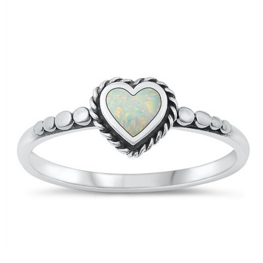 Small White Opal Heart Ring on a white background.